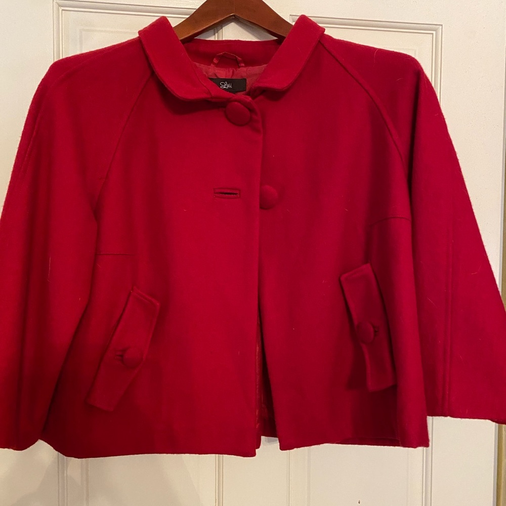 Red cropped cape-style coat.